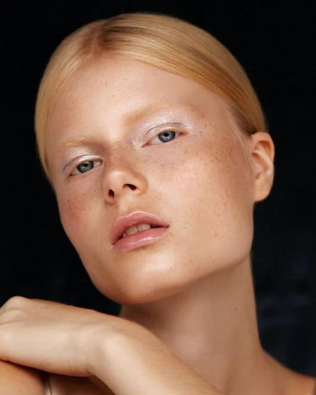 Editorial beauty portrait with radiant skin and soft shimmer