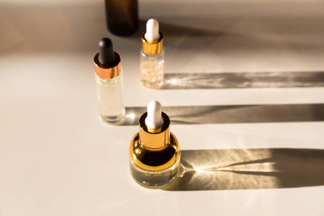 Luxury essence bottle photographed in dramatic light and shadow